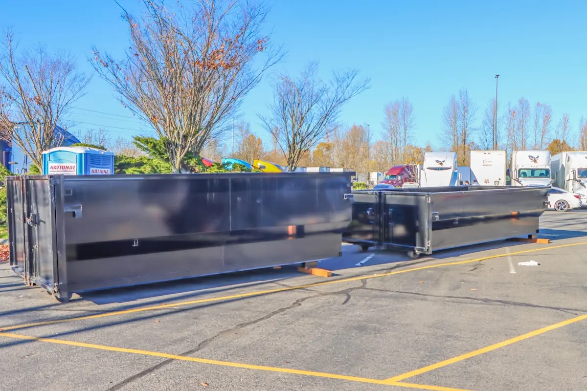 Professional dumpster rental service with roll-off container on residential driveway in Orchard Park